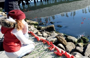 Baku residents bringing flowers to Seaside Boulevard to honor missing oil workers.  Azerbaijan, Dec.07, 2015